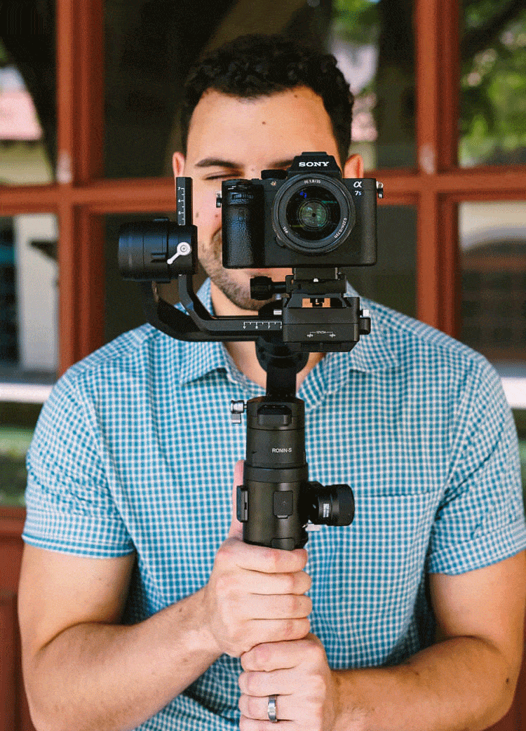 Ben, owner of Gen1 Creative, holding a Sony camera to shoot content creation for our Christian Marketing Agency